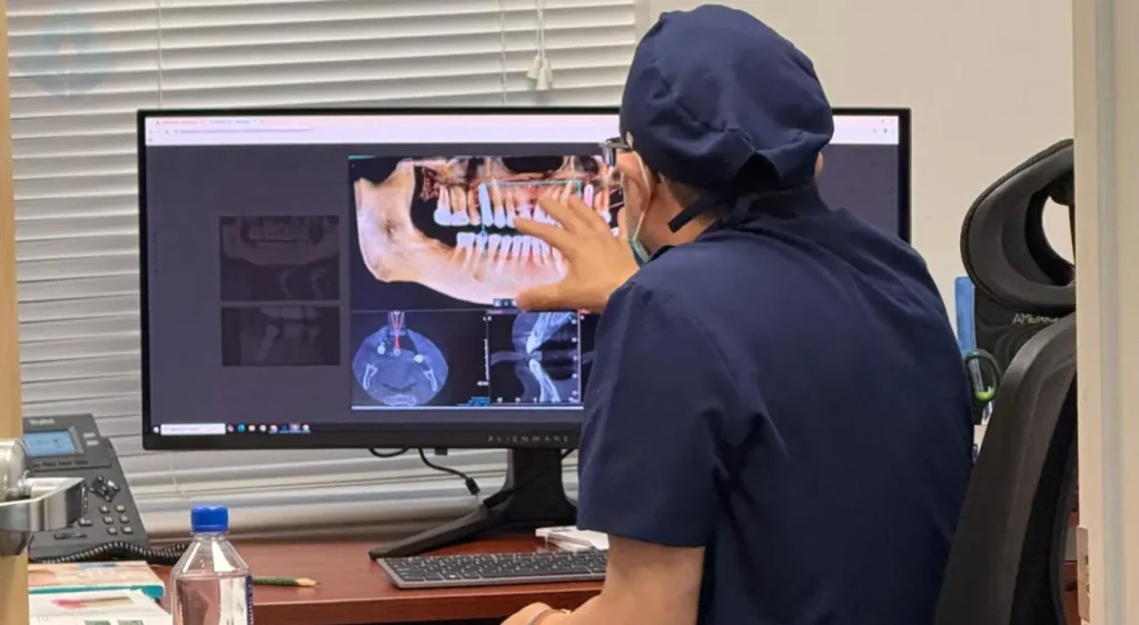 Dr. Aristo Carranza discussing functional veneers with a patient in his Westfield, NJ clinic
